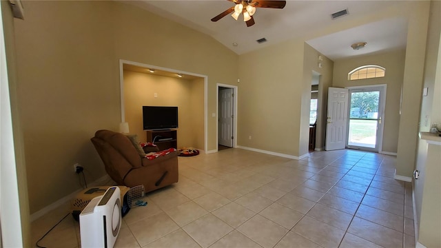 tiled living room featuring ceiling fan and high vaulted ceiling