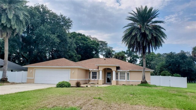 ranch-style house with a garage and a front yard