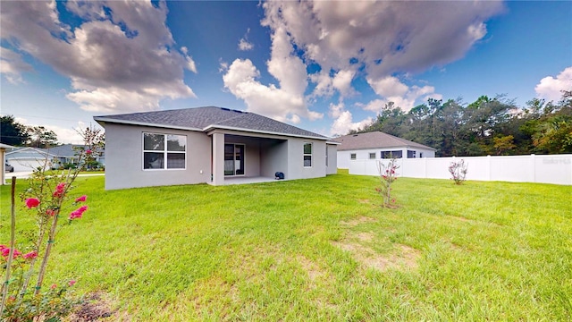 rear view of house with a lawn