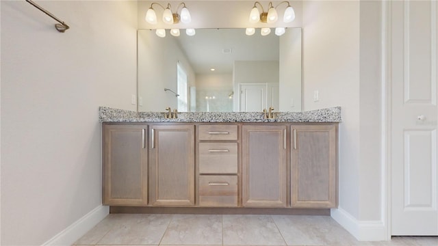 bathroom featuring a shower with door, vanity, and tile patterned floors