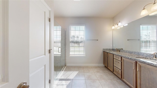 bathroom with vanity, tile patterned floors, and a shower with door