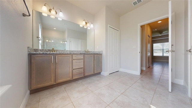 bathroom featuring walk in shower, vanity, and tile patterned floors