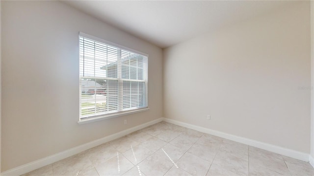 unfurnished room with light tile patterned flooring