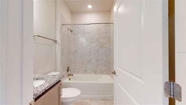 full bathroom featuring vanity, toilet, tiled shower / bath combo, and tile patterned flooring