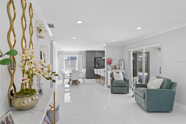 living room with crown molding and light tile patterned floors