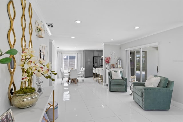 living area with ornamental molding, recessed lighting, visible vents, and light tile patterned floors