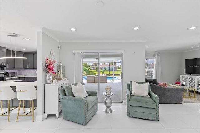 living room with light tile patterned floors, ornamental molding, and recessed lighting