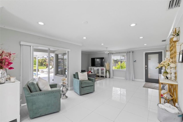 living room featuring ceiling fan, light tile patterned floors, and crown molding