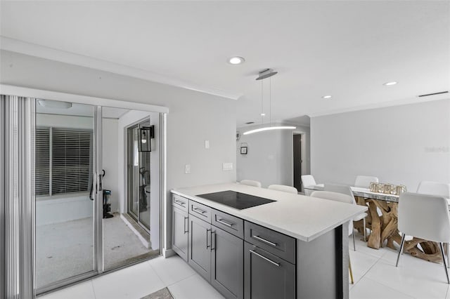 kitchen featuring decorative light fixtures, black electric stovetop, kitchen peninsula, light tile patterned flooring, and gray cabinets