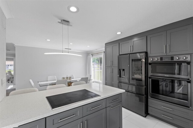 kitchen featuring black electric stovetop, double wall oven, gray cabinets, stainless steel fridge, and decorative light fixtures