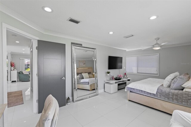 bedroom featuring ceiling fan, light tile patterned flooring, and crown molding