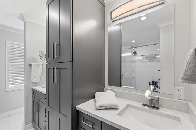 bathroom featuring a stall shower, vanity, and baseboards