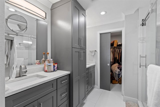 full bath with recessed lighting, a spacious closet, a stall shower, vanity, and tile patterned floors
