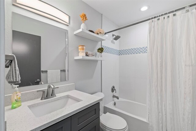 full bathroom with shower / bath combination with curtain, toilet, and vanity