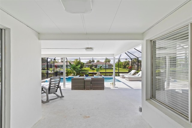 exterior space with glass enclosure and an outdoor pool