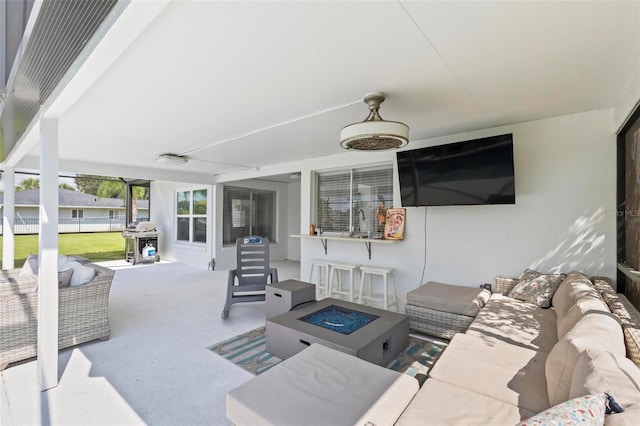 view of patio featuring a sink and an outdoor living space with a fire pit