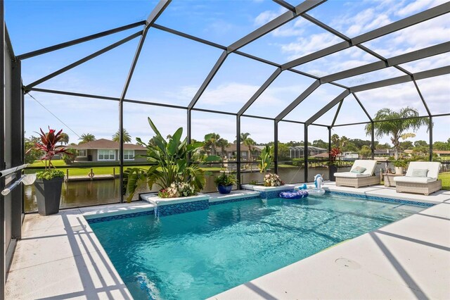 view of swimming pool featuring glass enclosure, pool water feature, and a patio area