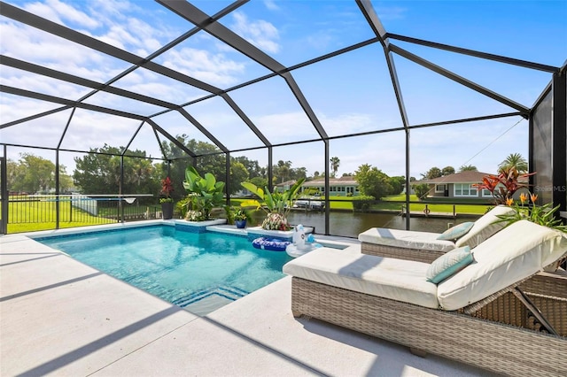 outdoor pool featuring glass enclosure, a water view, and a patio