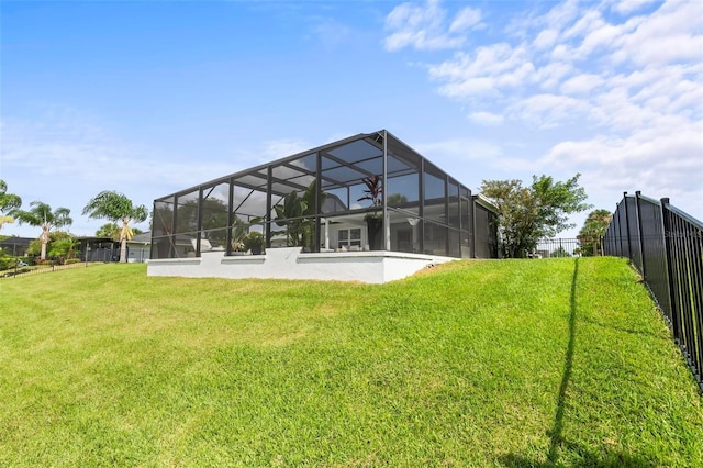 back of property featuring glass enclosure, a lawn, and fence private yard