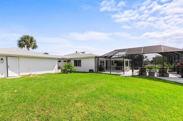 back of property featuring a lanai, a lawn, a patio, and stucco siding