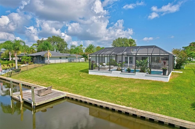back of property featuring an outdoor pool, a lawn, a fenced backyard, a lanai, and a water view