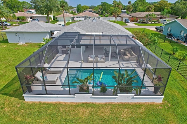 back of house featuring a fenced in pool, a patio, fence, a residential view, and a lanai
