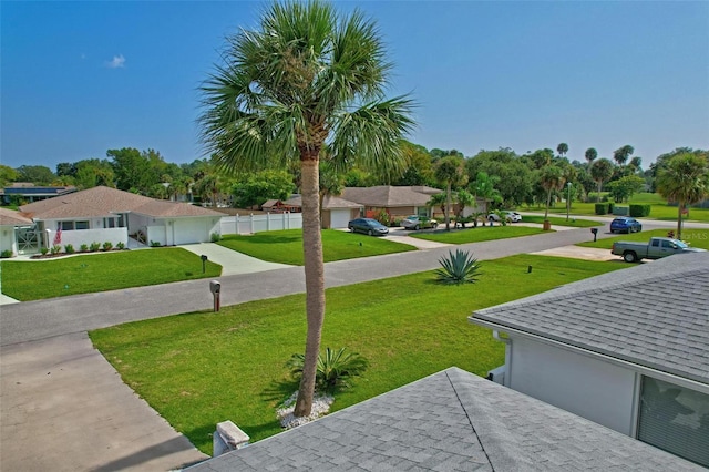 view of yard with fence and driveway