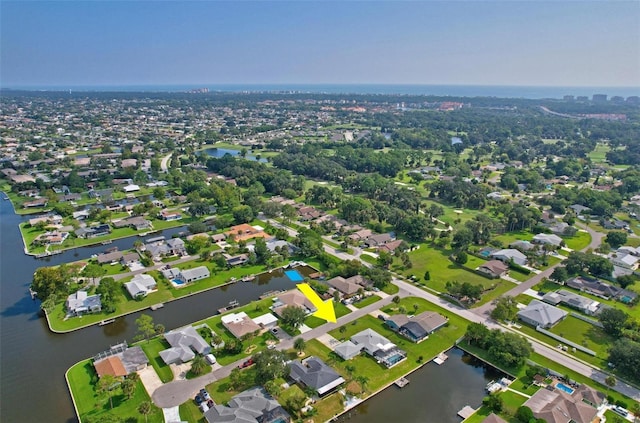birds eye view of property with a water view and a residential view