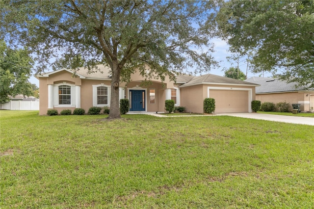 ranch-style home with stucco siding, concrete driveway, fence, a garage, and a front lawn