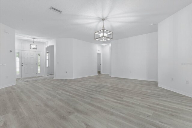 interior space featuring hardwood / wood-style floors and an inviting chandelier