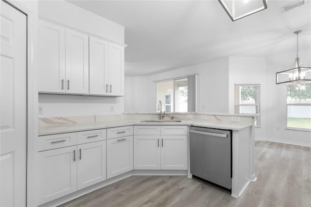 kitchen featuring visible vents, dishwasher, a peninsula, light wood-style floors, and a sink