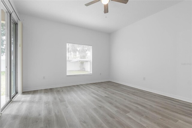 unfurnished room with ceiling fan and hardwood / wood-style floors