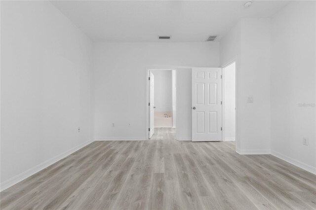 empty room with light hardwood / wood-style floors