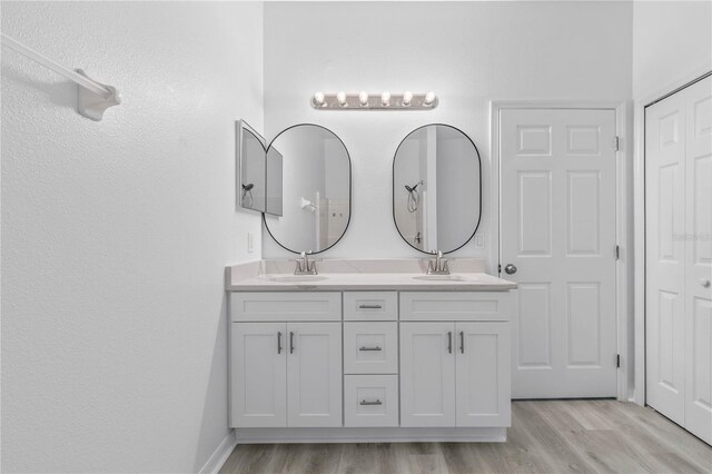 bathroom featuring hardwood / wood-style flooring and vanity