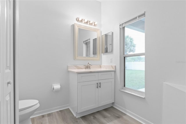 bathroom featuring hardwood / wood-style floors, toilet, and vanity