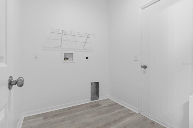 washroom with hardwood / wood-style floors, hookup for an electric dryer, and washer hookup