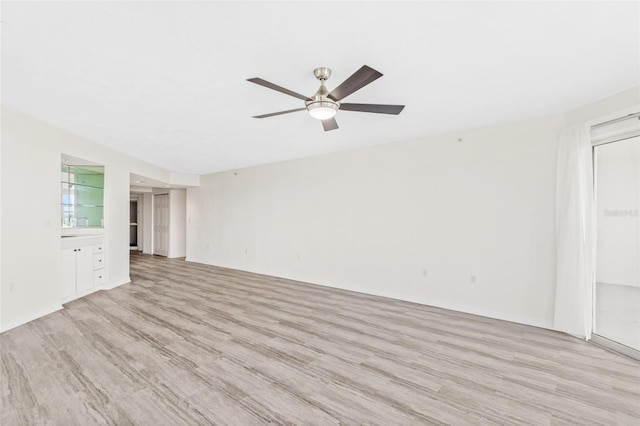 unfurnished living room featuring light wood-style floors and ceiling fan