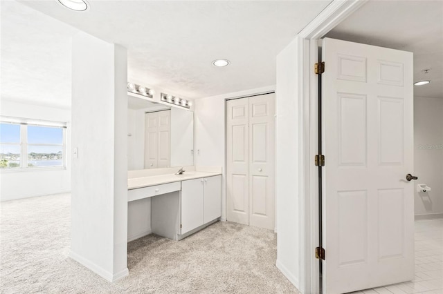 bathroom with recessed lighting, vanity, and baseboards