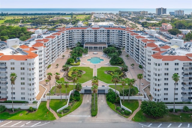 drone / aerial view featuring a view of city and a water view