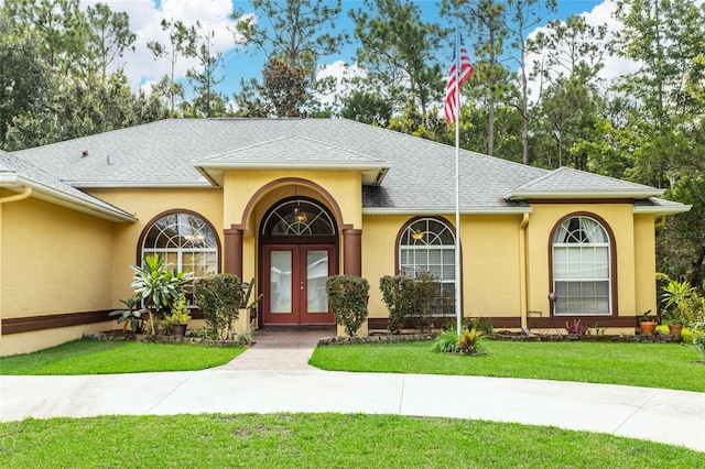 view of front facade featuring french doors and a front yard