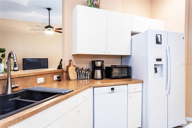 kitchen featuring white cabinets, sink, white appliances, and ceiling fan