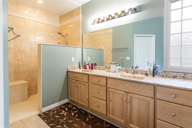 bathroom with dual bowl vanity and tile patterned floors