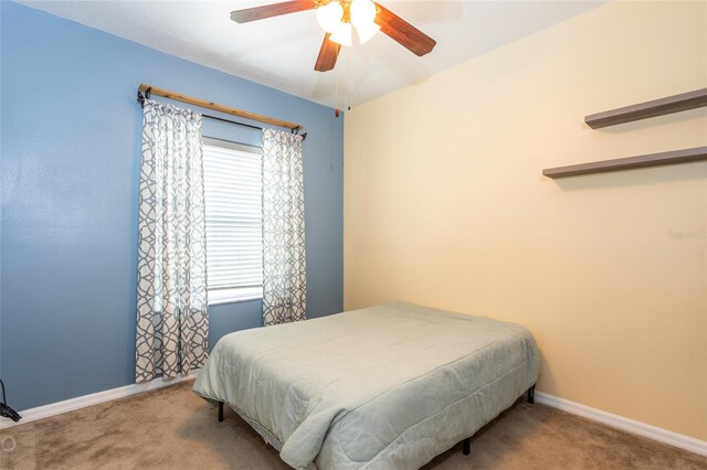 carpeted bedroom with multiple windows and ceiling fan