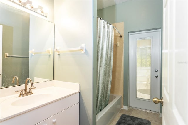 full bath featuring tile patterned flooring, shower / tub combo with curtain, and vanity