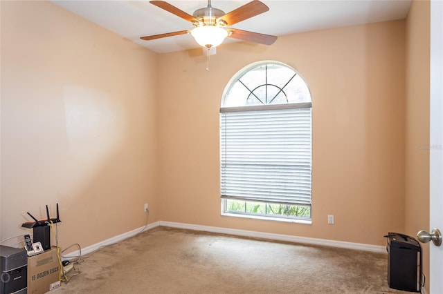 unfurnished room with baseboards, carpet floors, a ceiling fan, and a healthy amount of sunlight