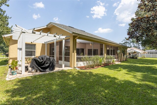 back of house with a pergola and a yard