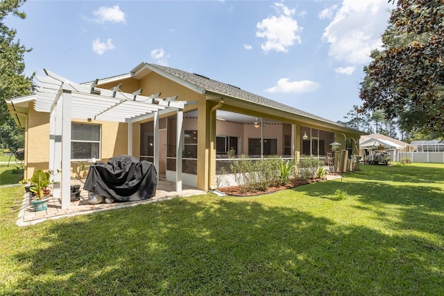 rear view of house featuring a sunroom, fence, a yard, a pergola, and stucco siding