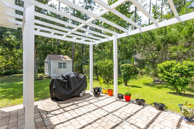 view of patio / terrace with a pergola, a grill, and a shed