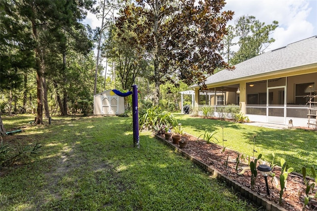 view of yard featuring a storage unit, an outdoor structure, and a sunroom