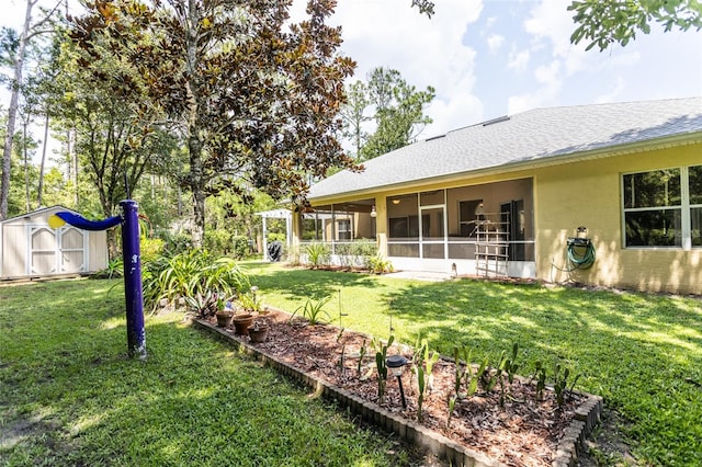 view of yard featuring a sunroom, a garden, an outdoor structure, and a shed